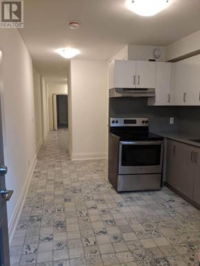Toronto (Dovercourt-Wallace Emerson-Junction) triplex for rent - A kitchen with a stove top oven and a tiled floor.