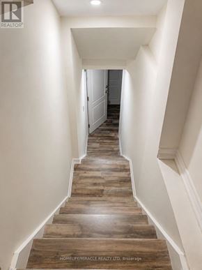 Brampton (Northwest Brampton) apartment for rent - A long hallway with wooden floors and white walls.