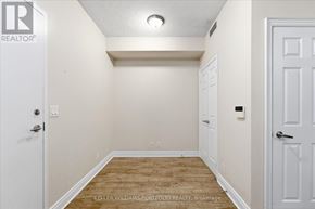 Markham (Unionville) condo for rent - A white door is on the left and a white door is on the right in a room with a wooden floor.