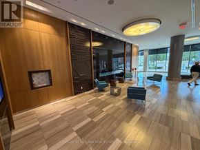 Toronto (Mimico) condo for rent - A wood panelled room with a person walking in the distance.