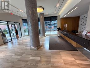Toronto (Mimico) condo for rent - A realtor's office with a reception desk and a person standing by the window.