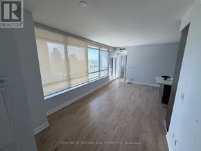 Toronto (Mimico) condo for rent - A spacious room with wooden flooring and large windows.