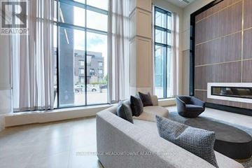 Mississauga (City Centre) condo for rent - A living room with a grey couch and a large window.
