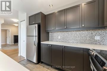 Ottawa condo for rent - A kitchen with a refrigerator, cabinets and a counter top.