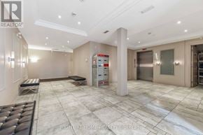 Ottawa condo for rent - A spacious, well-lit room with a marble floor and a large white pillar in the center.