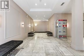 Ottawa condo for rent - A hallway with a bench and a vending machine.