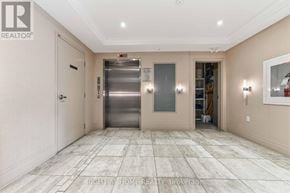 Ottawa condo for rent - A spacious hallway with a tiled floor and a stainless steel elevator.
