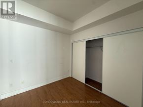 Toronto (Waterfront Communities) condo for rent - A room with a sliding door and wooden flooring.