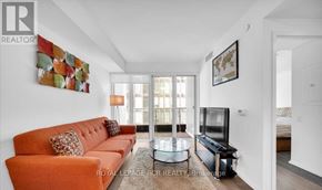 Toronto (Church-Yonge Corridor) condo for rent - A living room with a sofa, a coffee table, and a television.