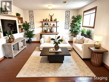Windsor apartment for rent - A living room with a white couch and a coffee table in the center.