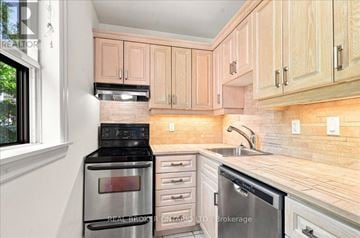 Toronto (Yonge-St. Clair) fourplex for rent - A kitchen with wooden cabinets and stainless steel appliances.