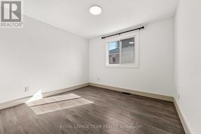 Ottawa triplex for rent - A white room with a window and a wooden floor.
