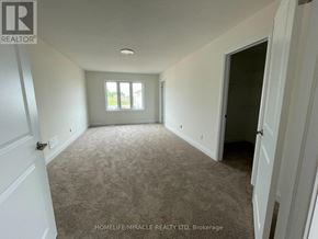 London South (South W) apartment for rent - A spacious room with carpeted floor and white walls, with a window and a door visible.