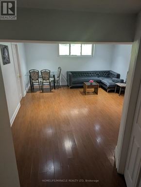 Toronto (Morningside) apartment for rent - A living room with a black couch, two chairs, and a coffee table.