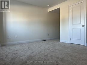 Markham (Angus Glen) townhouse for rent - A room with a carpeted floor and a white door.