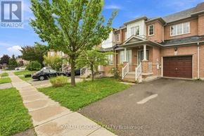 Newmarket (Woodland Hill) townhouse for rent - A house with a driveway and a tree in front of it.