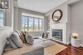 Markham (Cornell) townhouse for rent - A modern living room with a fireplace and a large window.