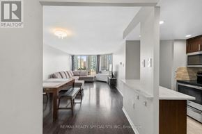Mississauga (Fairview) condo for rent - A modern living room with a kitchen area in the background.
