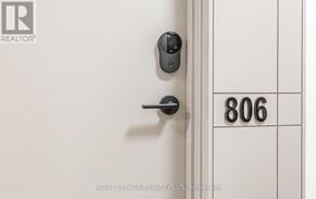Mississauga (Central Erin Mills) house for rent - A door with a black handle and a number 806 on the wall.