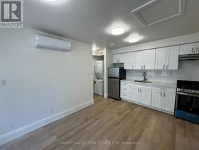 Toronto (Corso Italia-Davenport) apartment for rent - A kitchen with white cabinets and a blue oven.