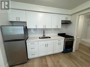 Toronto (Corso Italia-Davenport) apartment for rent - A kitchen with white cabinets and a stainless steel refrigerator.