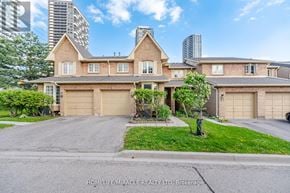 Mississauga (Hurontario) townhouse for rent - A large, well-maintained house with a driveway in front.