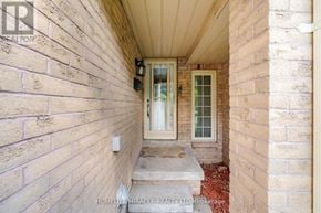 Mississauga (Hurontario) townhouse for rent - A brick house with a glass door and a window.