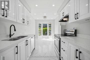 Mississauga (Hurontario) townhouse for rent - A modern kitchen with white cabinets and a black faucet.