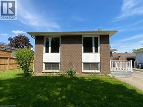 Welland apartment for rent - A house with a white porch and a brown brick exterior.
