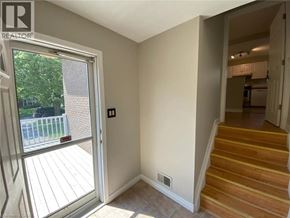 Welland apartment for rent - A room with a staircase leading to another room.