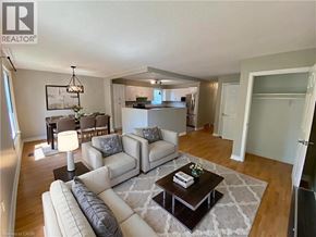 Welland apartment for rent - A well-lit living room with a white sofa set and a coffee table.