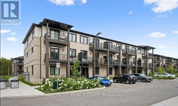 Guelph (Kortright East) townhouse for rent - A building with the logo "REALTOR" on the top left corner.
