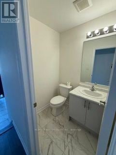 Kawartha Lakes (Lindsay) townhouse for rent - A bathroom with a toilet, sink and mirror.