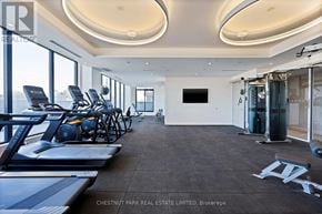 Toronto (Thorncliffe Park) townhouse for rent - A gym with treadmills, exercise bikes, and weights.