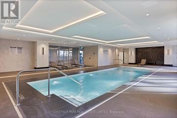 Toronto (Thorncliffe Park) townhouse for rent - A large indoor swimming pool with a glass wall.