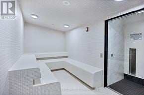 Toronto (Thorncliffe Park) townhouse for rent - A white tiled bathroom with a glass door leading to a shower.