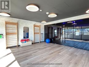 Mississauga (Cooksville) condo for rent - A spacious room with wooden floors and a large window with blinds.