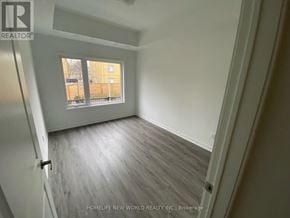 Toronto (Englemount-Lawrence) townhouse for rent - A room with a window and wooden flooring.