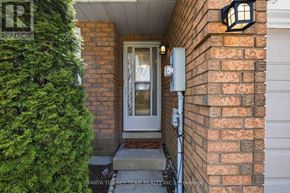 Clarington (Courtice) townhouse for rent - A house entrance with a glass door and a brick wall.
