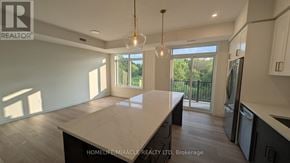 Guelph (Riverside Park) townhouse for rent - A spacious kitchen with a large island in the middle.
