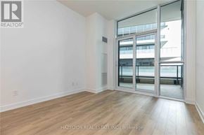 Toronto (Niagara) condo for rent - A room with a sliding glass door leading to a balcony.