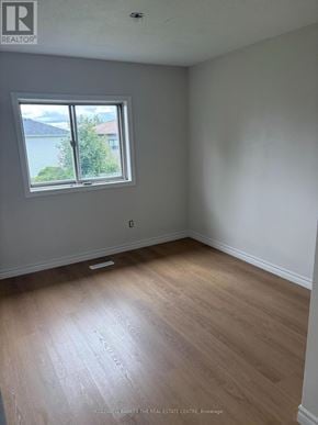 Barrie (Holly) townhouse for rent - A room with a window and wooden flooring.