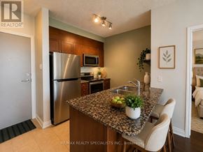 Mississauga (Fairview) condo for rent - A kitchen with granite countertops and stainless steel appliances.