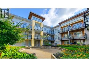 Burnaby apartment for rent - A sunny day at a modern apartment complex with greenery and flowers.
