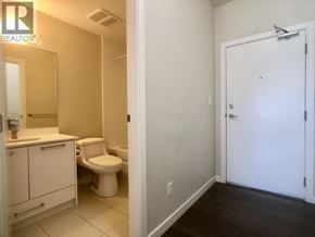 Burnaby apartment for rent - A bathroom with a toilet, sink, and medicine cabinet.