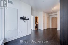 Toronto (Waterfront Communities) condo for rent - A brokerage image of a room with white walls and wood flooring.