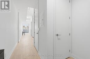 Toronto (Thorncliffe Park) condo for rent - A hallway with white walls and a wooden floor.