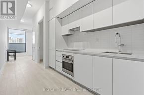 Toronto (Thorncliffe Park) condo for rent - A white kitchen with a sink and a window.