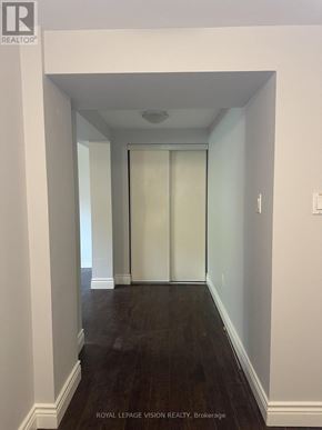 Toronto (Woburn) apartment for rent - A hallway with a glass door and wooden floors.