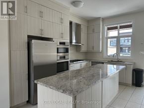 Vaughan (Patterson) townhouse for rent - A kitchen with granite countertops and stainless steel appliances.